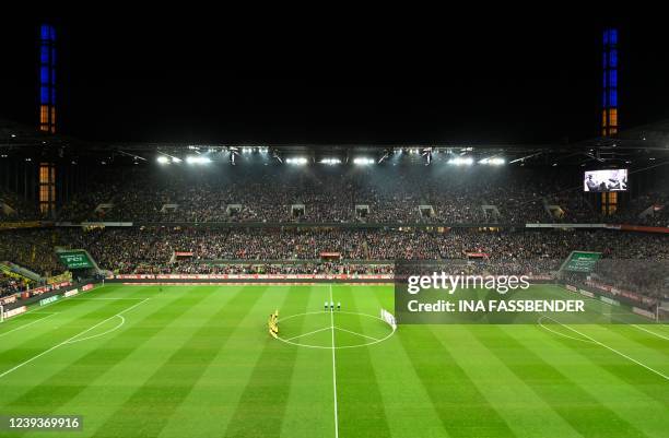 Dortmund's and Cologne's players are seen on the pitch next to a huge peace sign during the German first division Bundesliga football match FC...