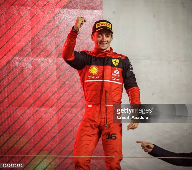 Ferrari's Monacan pilot Charles Leclerc celebrates his winning at Bahrain Formula One Grand Prix at the Bahrain International Circuit in Bahrain,...