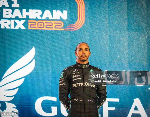 Mercedesâs team British pilot Lewis Hamilton poses after winning third place in Bahrain Formula One Grand Prix at the Bahrain International Circuit...