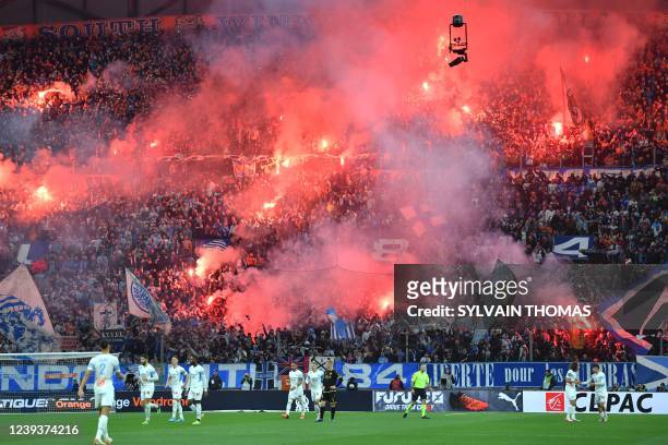 Marseille's supporters light flares prior to the French L1 football match between Olympique de Marseille and OGC Nice at the Velodrome Stadium, in...