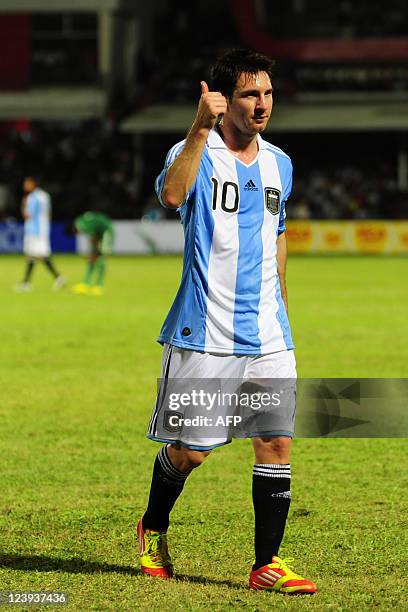 Argentina captain Lionel Messi acknowledges the crowd during a friendly match against Nigeria at the Bangabandhu National Stadium in Dhaka on...