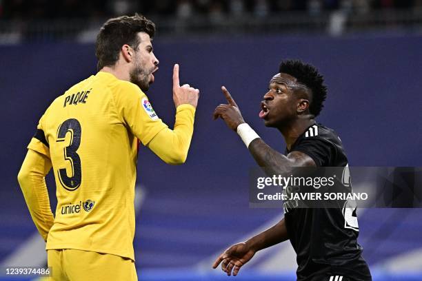 Barcelona's Spanish defender Gerard Pique and Real Madrid's Brazilian forward Vinicius Junior argue during the Spanish League football match between...