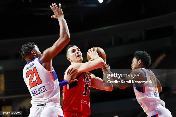 Marco Simonovic of the Windy City Bulls drives to the basket against MJ Walker and Tra Holder of the Westchester Knicks during the second half of an...