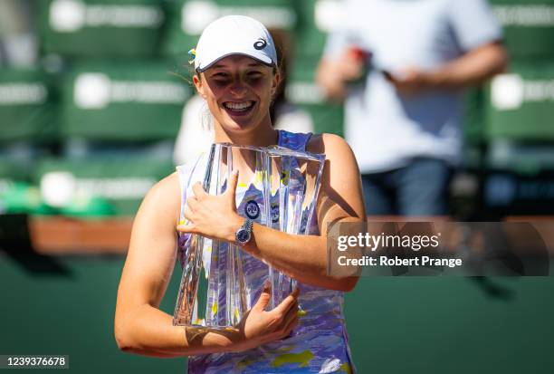 Iga Swiatek of Poland poses with the champions trophy after defeating Maria Sakkari of Greece in the Women's Singles final of the 2022 BNP Paribas...