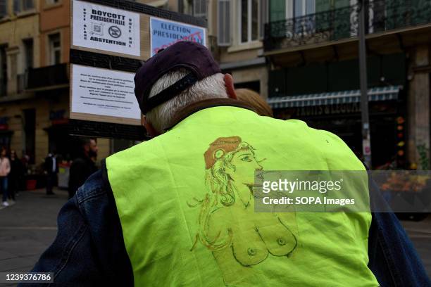 Protester is seen wearing a yellow vest with a drawing of âMarianneâ symbol of freedom during the demonstration in Marseille. Activists from the...