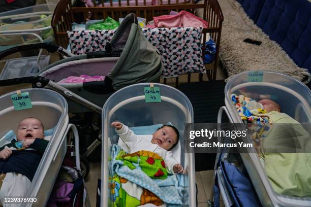 Babies lay next to each other in a separate crib in a makeshift nursery underground in the outskirts of Kyiv, Ukraine, Sunday, March 20, 2022. More...