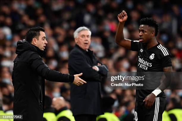 Xavi Hernandez head coach of Barcelona and Vinicius Junior of Real Madrid argues during the La Liga Santander match between Real Madrid CF and FC...