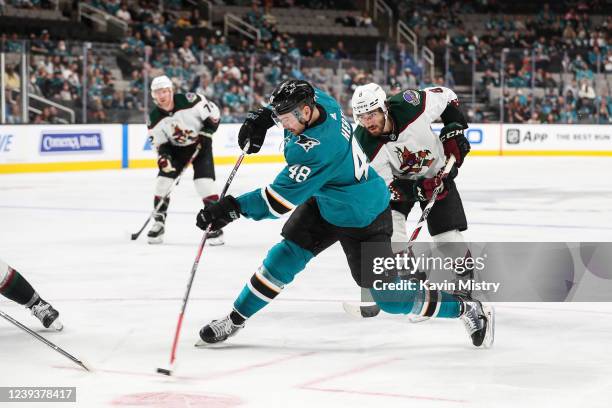 Tomas Hertl of the San Jose Sharks takes a shot at the goal against Nick Schmaltz of the Arizona Coyotes at SAP Center on March 20, 2022 in San Jose,...