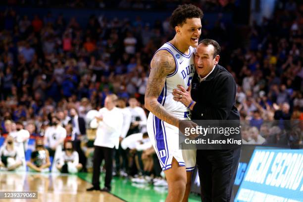 Paolo Banchero celebrates with head coach Mike Krzyzewski of the Duke Blue Devils near the end of their game against the Michigan State Spartans in...