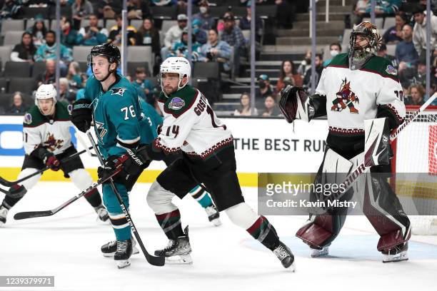Shayne Gostisbehere of the Arizona Coyotes chases after puck along with Jonathan Dahlen of the San Jose Sharks against the Arizona Coyotes at SAP...