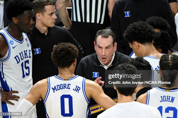 Head coach Mike Krzyzewski of the Duke Blue Devils huddles with his players in the closing minutes of the game against the Michigan State Spartans...