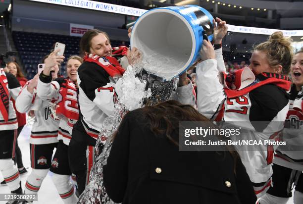 Head Coach Nadine Muzerall of the Ohio State Buckeyes has water dumped on her after the Buckeyes defeated the Minnesota Duluth Bulldogs 3-2 during...