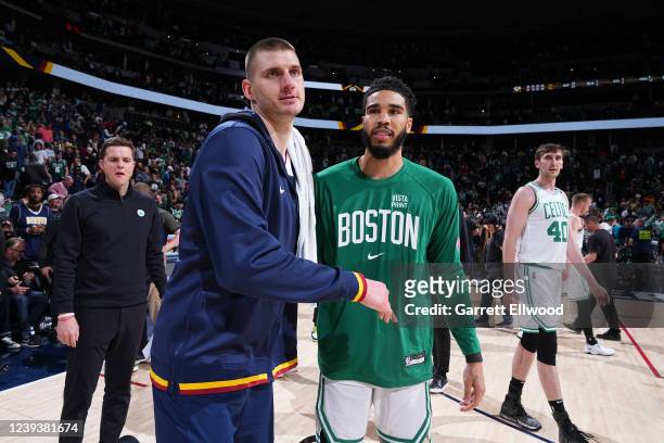 Nikola Jokic of the Denver Nuggets and Jayson Tatum of the Boston Celtics embrace after the game on March 20, 2022 at the Ball Arena in Denver,...