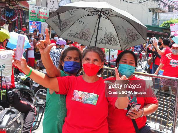 Women supporting Bongbong Marcos Jr are flashing their V sign. Bongbong Marcos Jr. Visits the cities of Navotas and Malabon as part of UniTeam's...