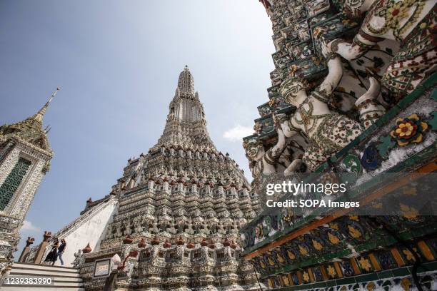 Foreign tourists walk around Wat Arun. Wat Arun or also know as Wat Arun Ratchawararam Ratchawaramahawihan is a Buddhist temple located in Bangkok...