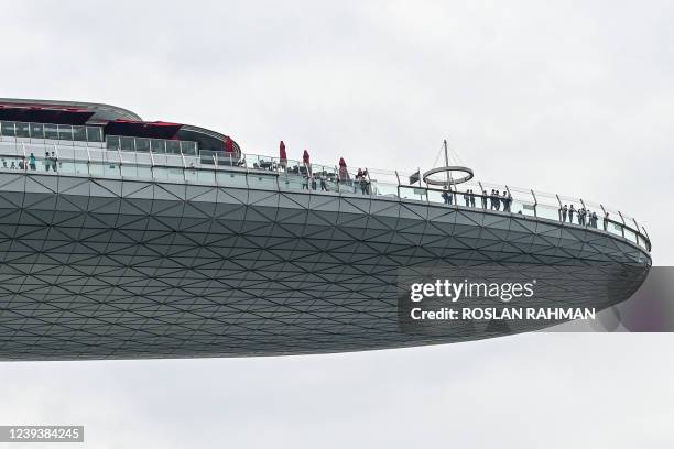 People view the city skyline from the Marina Bay Sands SkyPark in Singapore on March 21, 2022.