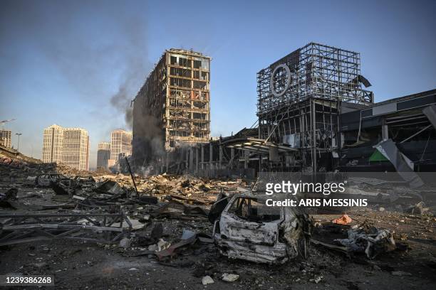Smoke billows after a Russian attack on the Retroville shopping mall abd residential district of Kyiv on March 21, 2022. - At least six people were...