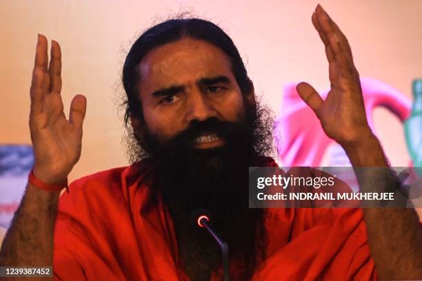 Indian yoga guru and non-executive director of Ruchi Soya Industries Limited Baba Ramdev speaks during an event for the announcement of the company's...