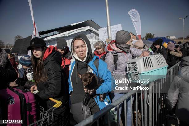 Ukrainians with pets wait at the long lines, formed as Ukranian refugees wait to board the bus in Medyka assisted by Polish armed forces. Civilian...