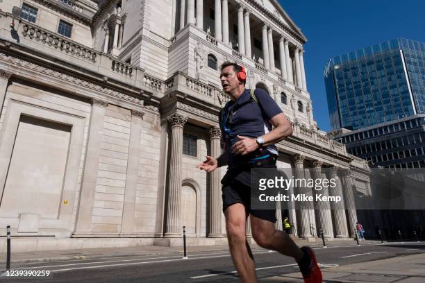 Runner outside the Bank of England in the City of London on 18th March 2022 in London, United Kingdom. The Bank of England raised the UK's interest...