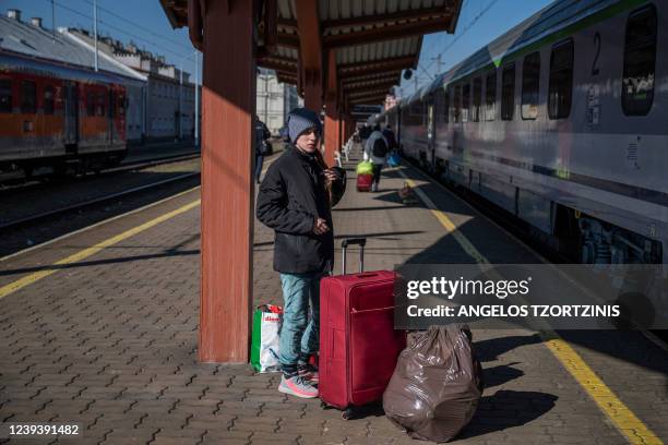 Ukrainian evacuee stands on a platform as he arrives at the train station in Przemysl, near the Polish-Ukrainian border, which became one of the main...