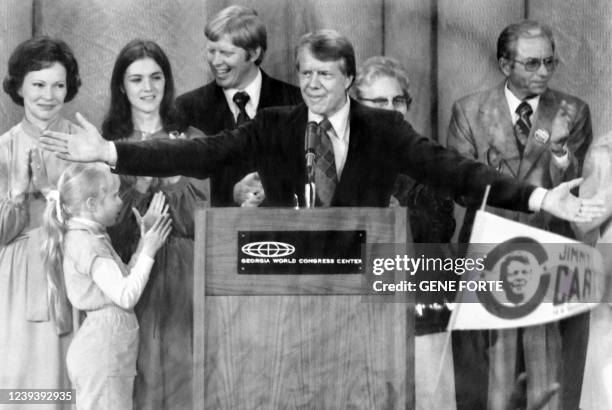Democratic presidential candidate Jimmy Carter , flanked by his wife Rosalynn , his daughter Amy and family, reacts during a rally in Atlanta. Carter...