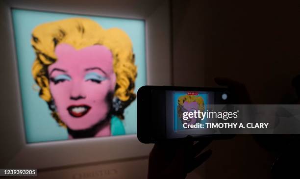 Journalist takes photos of Andy Warhols 1964 Shot Sage Blue Marilyn.during a press preview March 21, 2022 in New York. - The iconic Andy Warhol...