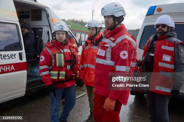 Red Cross rescuers evacuate local residents from the frontline as artillery fire raged on March 8, 2022 in Irpin, Ukraine. Russia invaded Ukraine on...