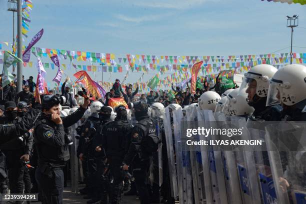 Turkish riot police officers stand guard during a gathering of Turkish Kurds for Newroz celebrations marking the Persian New Year in Diyarbakir,...