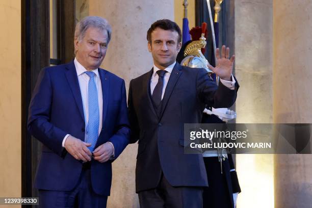 France's President Emmanuel Macron waves as he welcomes Finland's President Sauli Niinistoe prior to talks at the presidential Elysee Palace in Paris...