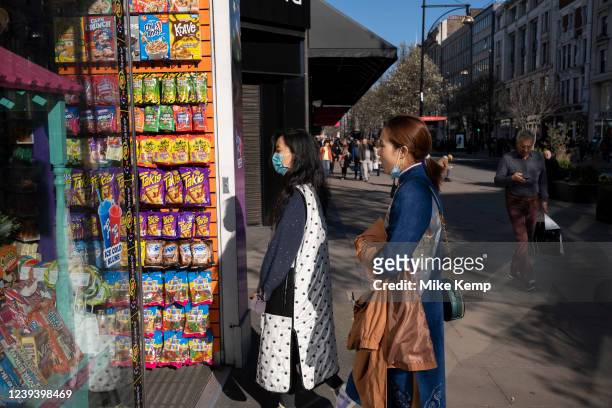 Shoppers stop to go into an American candy shop on Oxford Street on 18th March 2022 in London, United Kingdom. Oxford Street is a major retail centre...