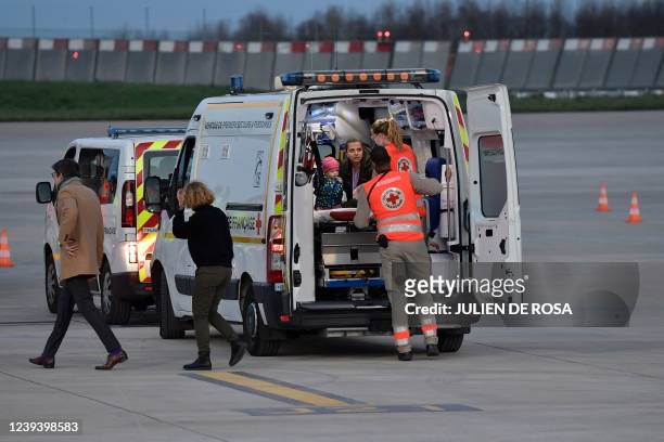 Little girl sits in an ambulance as twenty Ukrainian children who suffer from cancer and leukemia arrive at Orly airport in Orly, near Paris, on...