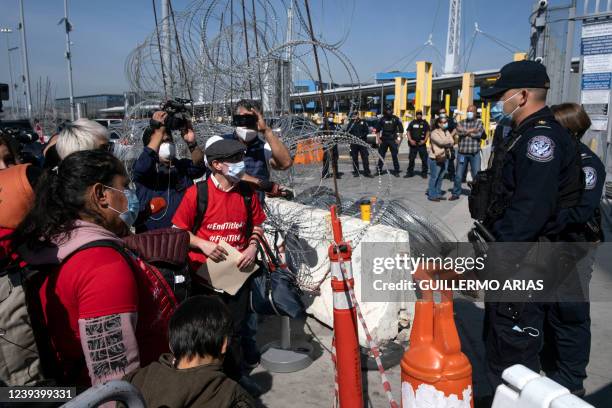 Small group of asylum seekers , ask for asylum at the border during a protest against Title 42 policy on the Mexican side of the San Ysidro Crossing...