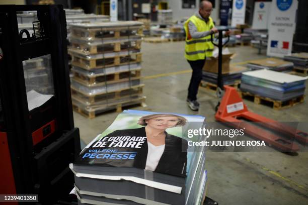 Employees prepare official campaign posters of French right-wing Les Republicains Ile-de-France Regional Council President and presidential candidate...