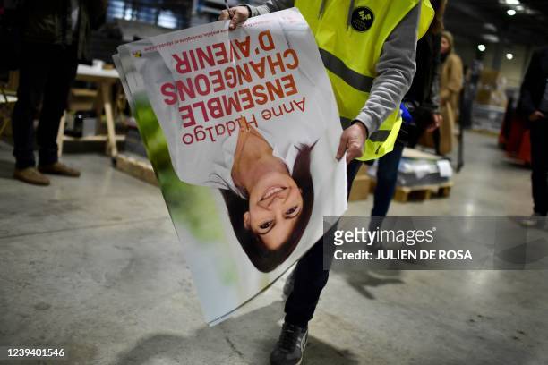 An employee holds an official campaign posters of French socialist party presidential candidate Anne Hidalgo at France Affichage Plus, the logistical...