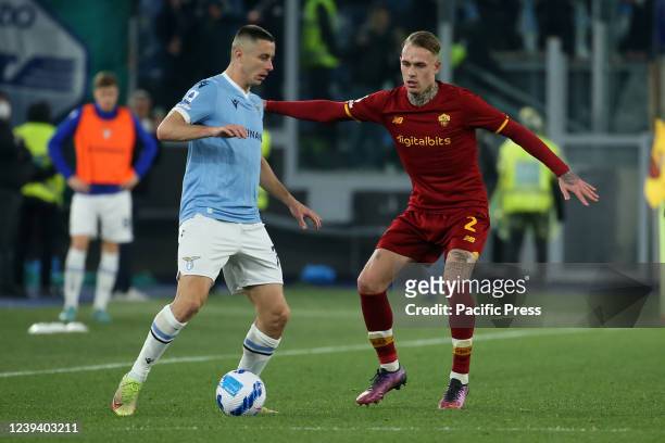 Adam Marusic and Rick Karsdorp compete for the ball during the Serie A match between AS Roma and SS Lazio at Stadio Olimpico. AS Roma wins 3-0.