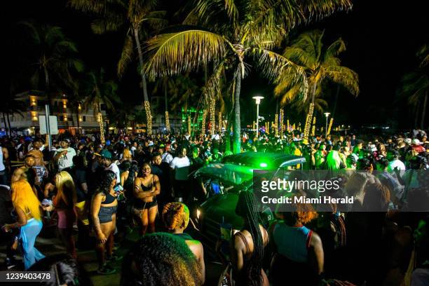 Miami Beach Police vehicle cuts through crowds near Ocean Drive during Spring Break in Miami Beach, Florida, on Saturday, March 19, 2022.