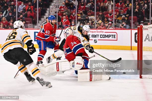 Brad Marchand of the Boston Bruins gets the puck past goaltender Jake Allen of the Montreal Canadiens to score during the first period at Centre Bell...