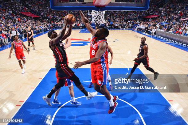 Paul Millsap of the Philadelphia 76ers blocks the shot of Jimmy Butler of the Miami Heat on March 21, 2022 at Wells Fargo Center in Philadelphia,...