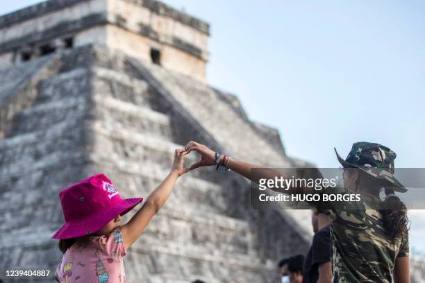 People surround the Kukulcan Pyramid at the Mayan archaeological site of Chichen Itza in Yucatan State, Mexico, during the celebration of the spring...