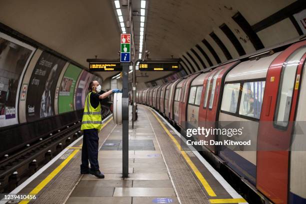 Worker sanitizes at Clapham Common station on June 01, 2020 in London, England. The British government further relaxed Covid-19 quarantine measures...