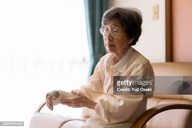 an old woman who has a broken wrist and is being treated at home - healing wound stock pictures, royalty-free photos & images