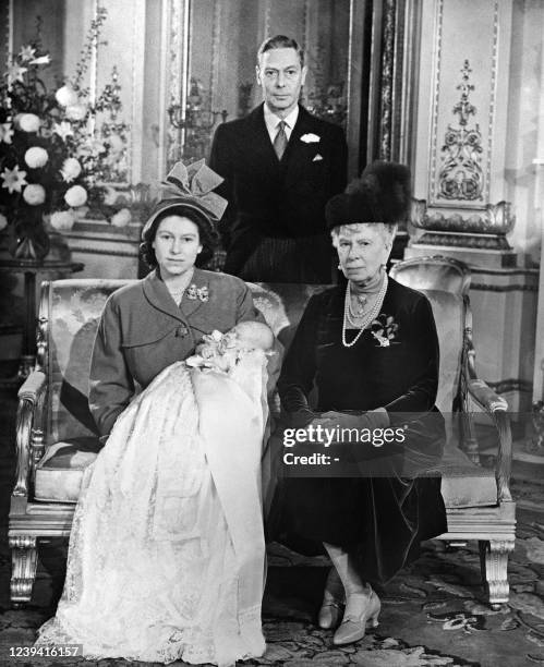 King George VI, Princess Elizabeth's father , Queen Mary, mother of the King and Princess Elizabeth pose during the christening of Prince Charles ,...