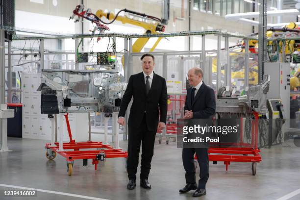 Tesla CEO Elon Musk stands next to German Chancellor Olaf Scholz during the official opening of the new Tesla electric car manufacturing plant on...