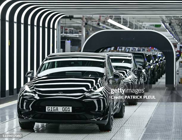 Line of electric vehicles of the model Y is pictured during the start of the production at Tesla's "Gigafactory" on March 22, 2022 in Gruenheide,...