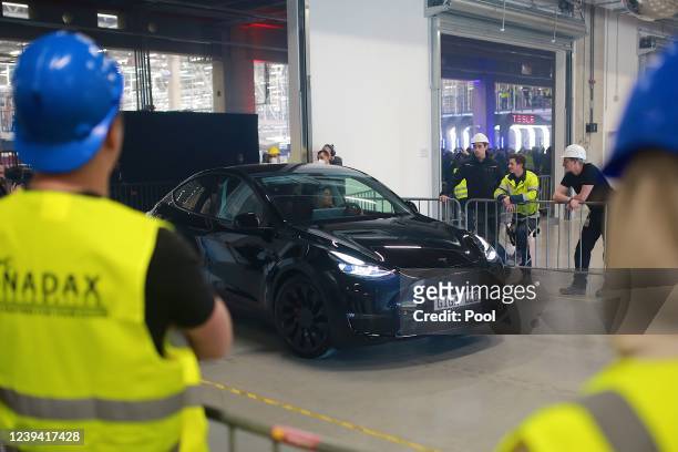 New Tesla car leaves the factory during the official opening of the new Tesla electric car manufacturing plant on March 22, 2022 near Gruenheide,...