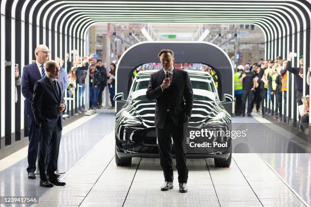 German Chancellor Olaf Scholz , Brandenburg State Premier Dietmar Woidke and Tesla CEO Elon Musk attend the official opening of the new Tesla...