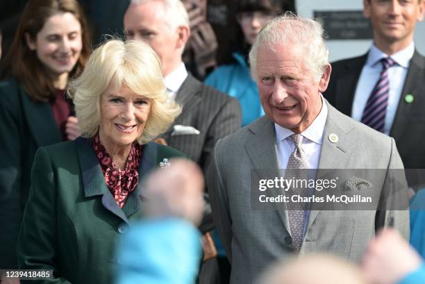 Prince Charles, Prince of Wales and Camilla, Duchess of Cornwall watch local children perform a dance from the musical Grease as they visit Cookstown...