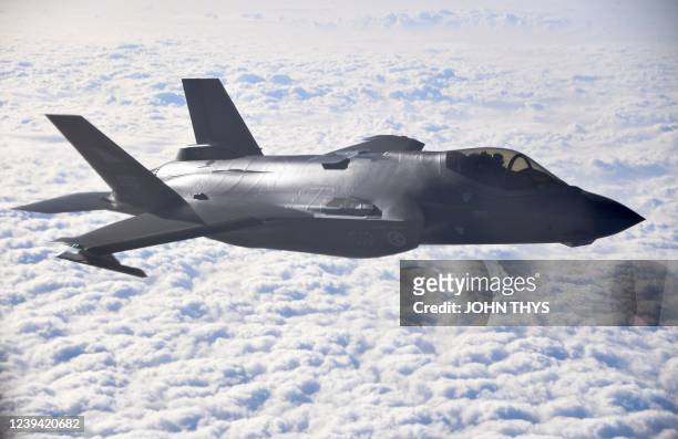 This photograph taken through a window of a NATO Airbus A330 aircraft refuelling tanker shows a Norwegian F-35 fighter jet during NATO exercise 'Cold...