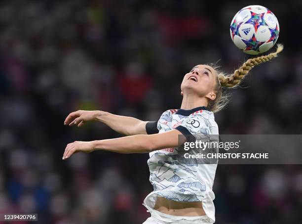 Bayern Munich's German midfielder Giulia Gwinn jumps for the ball during the UEFA Women's Champions League quarter final first leg match FC Bayern...
